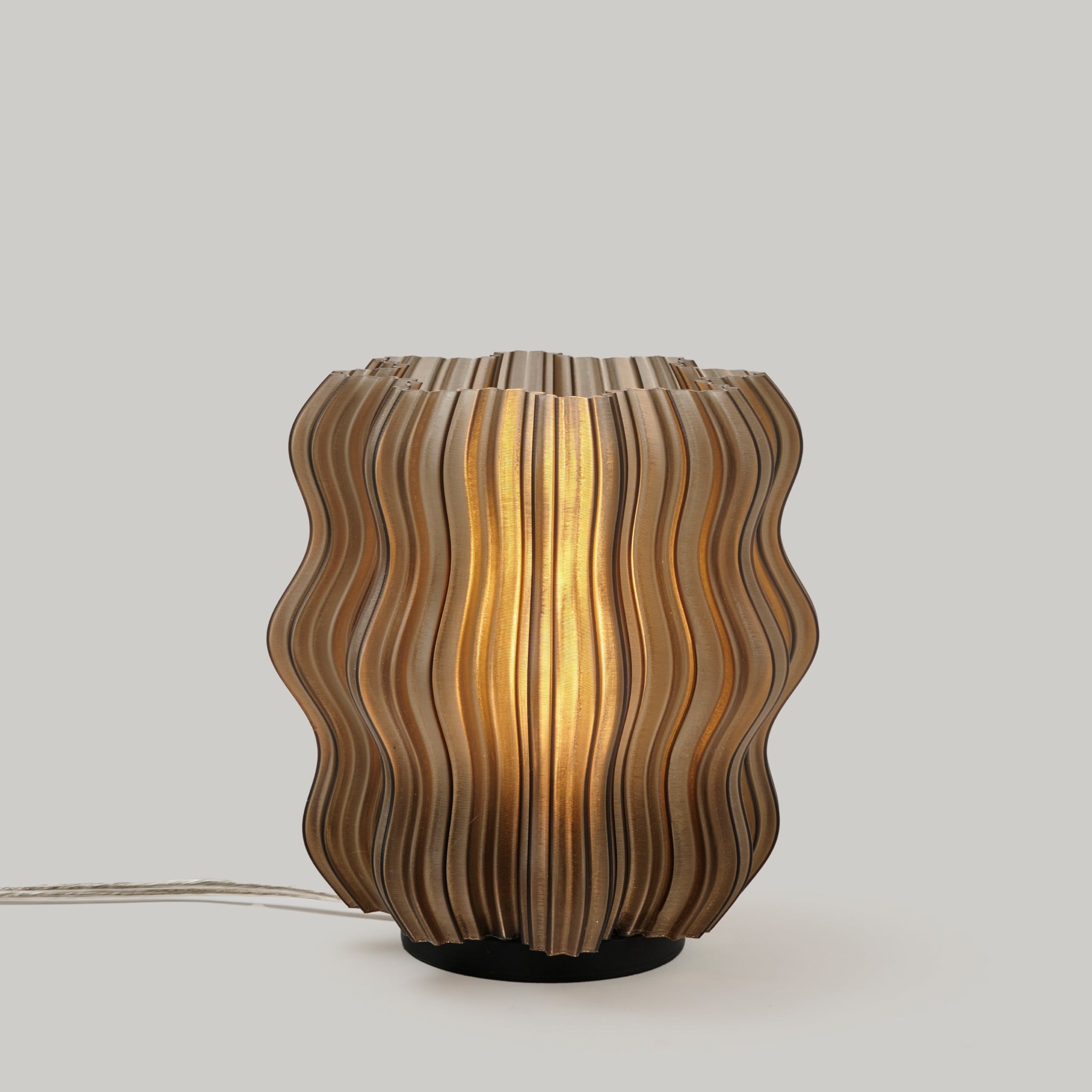 Wavy-patterned table lamp on a plain background