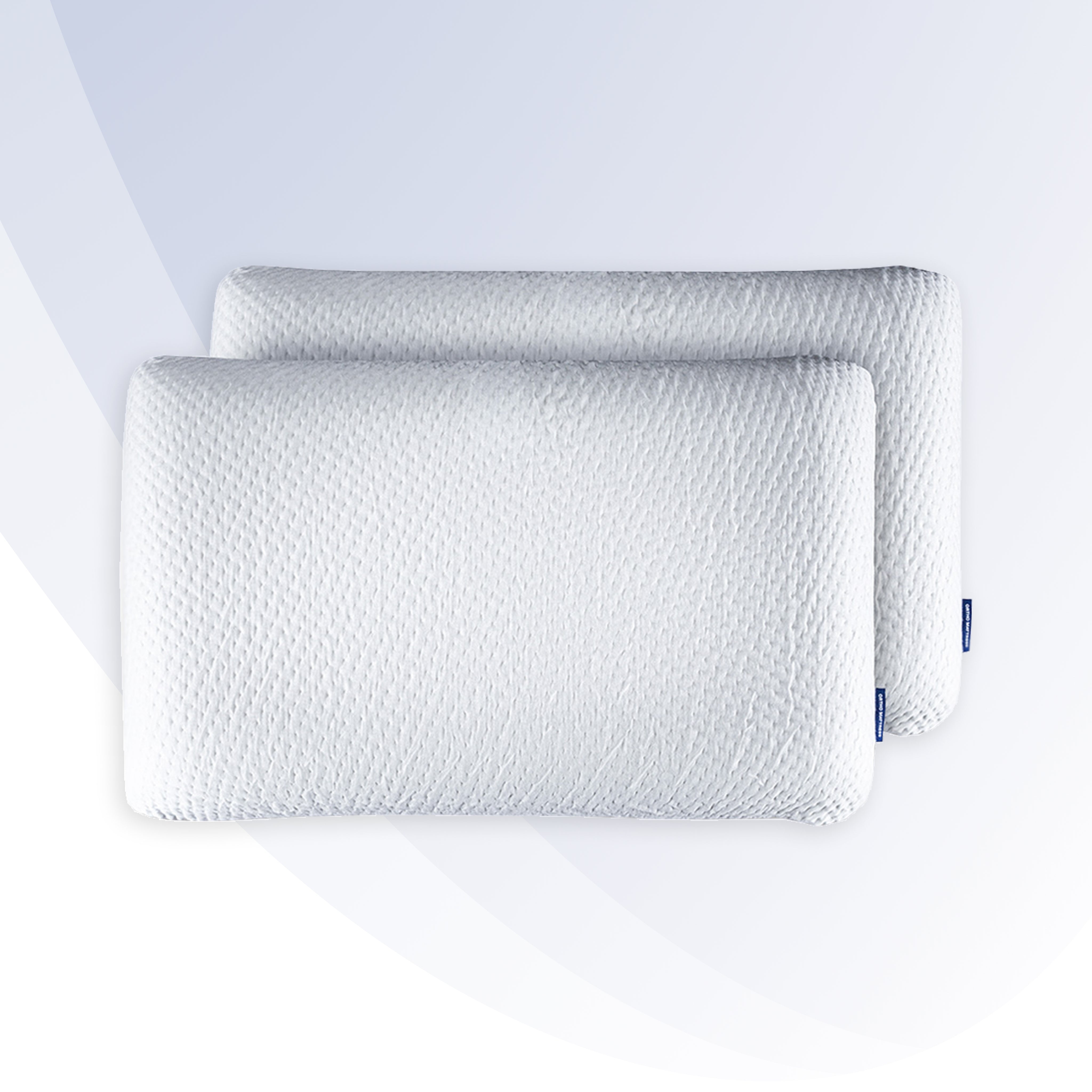 Two white pillows with a textured pattern on a light gray background