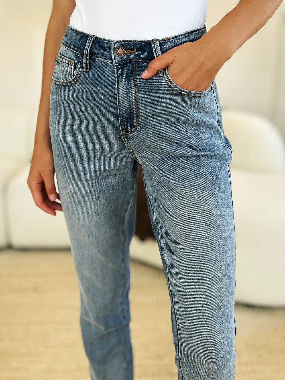 Person wearing blue jeans with a blurred background