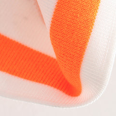 Close-up of a sock with orange and white stripes on a light background