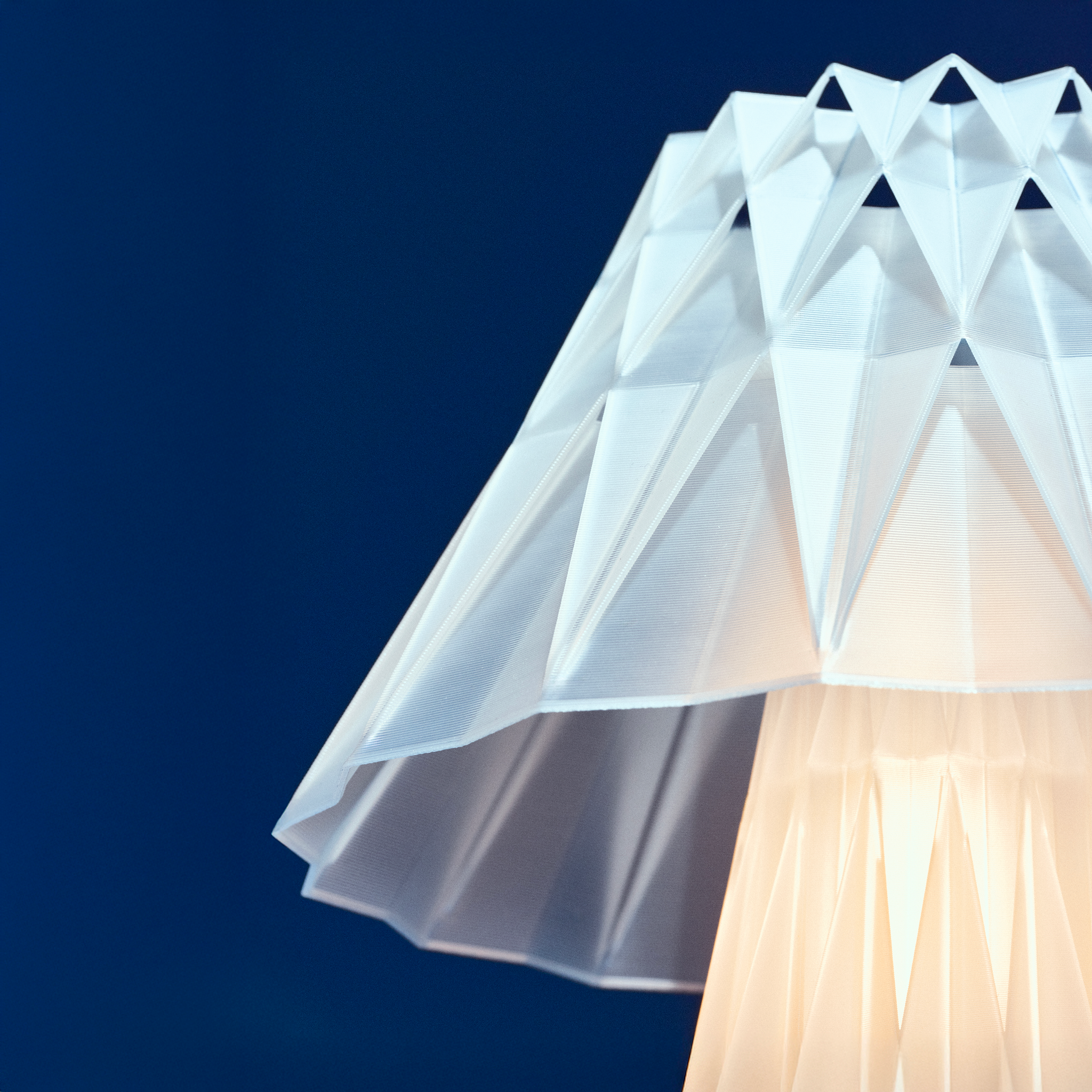 Modern lamp with geometric design on a dark blue background