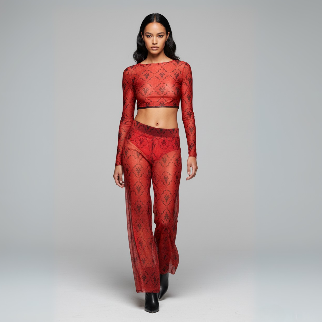 Model wearing a red lace outfit on a gray background