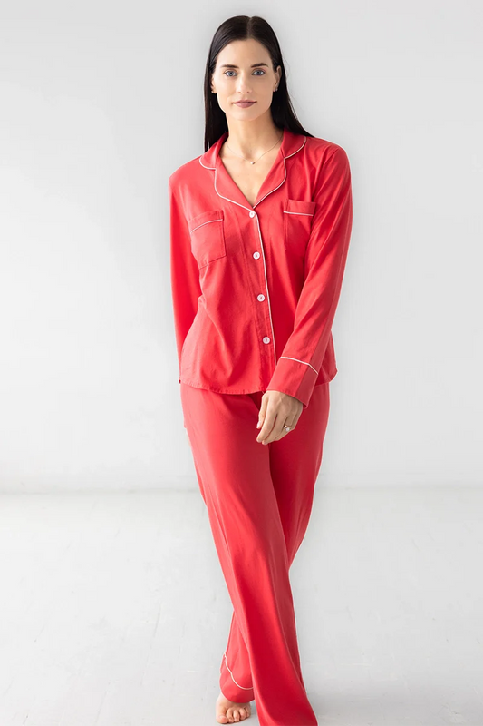 Woman wearing red pajamas against a white background