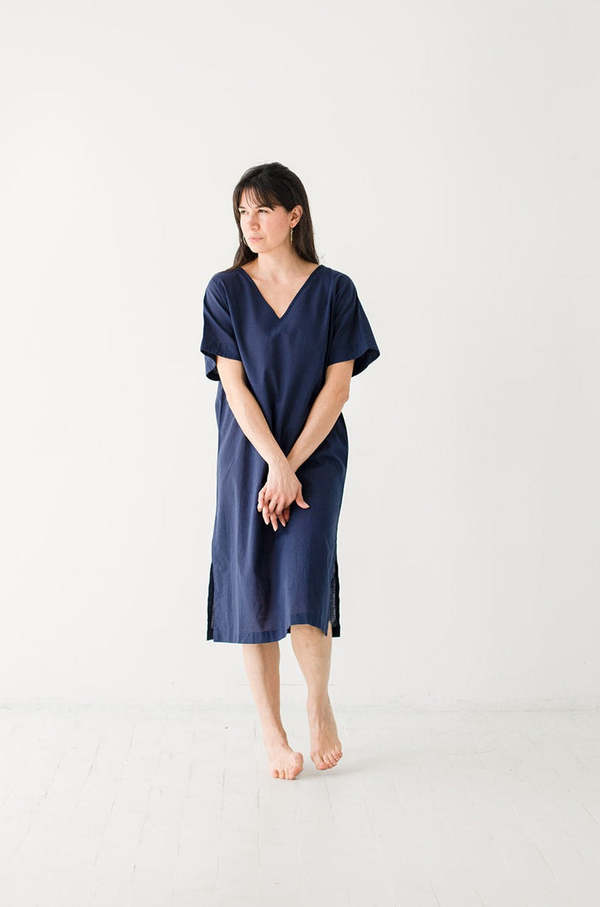 Woman wearing a blue dress on a white background