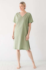 Woman wearing a green dress against a white background