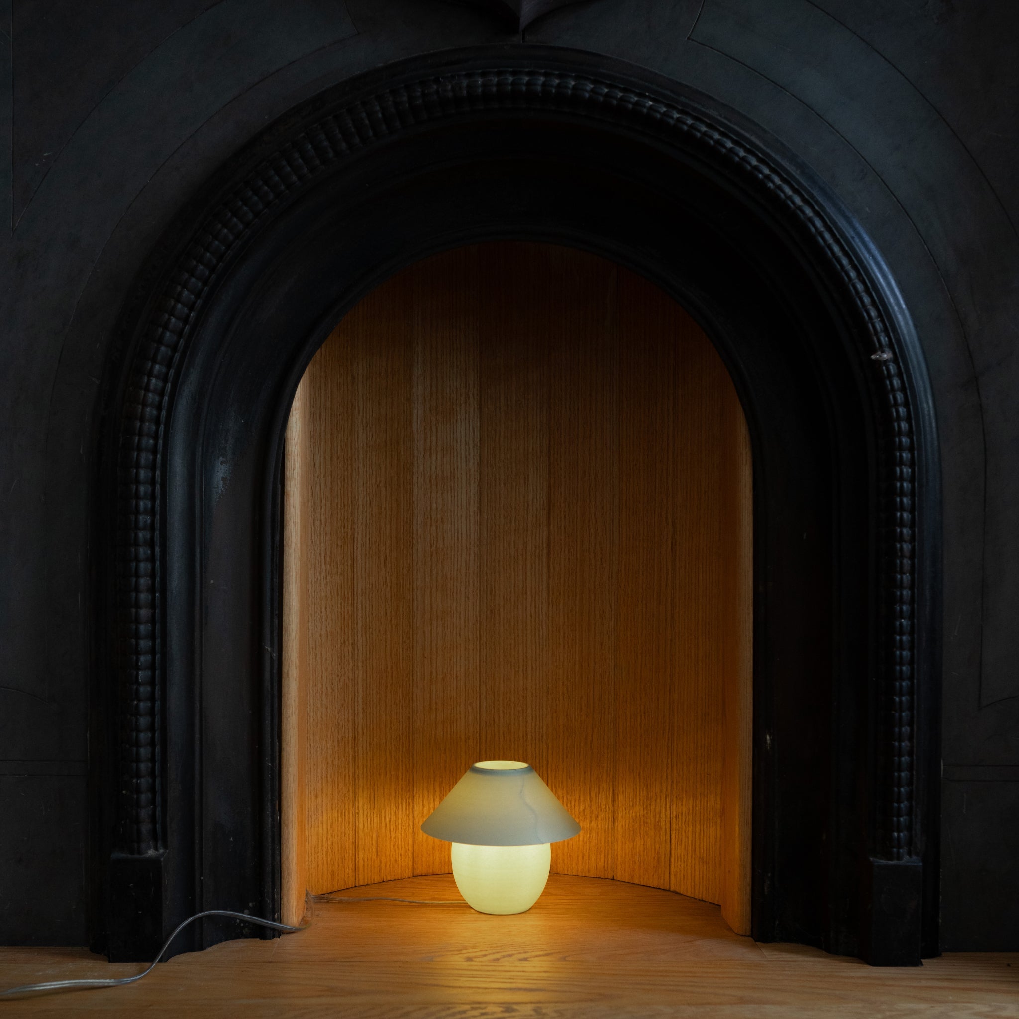 Small lamp inside a dark fireplace