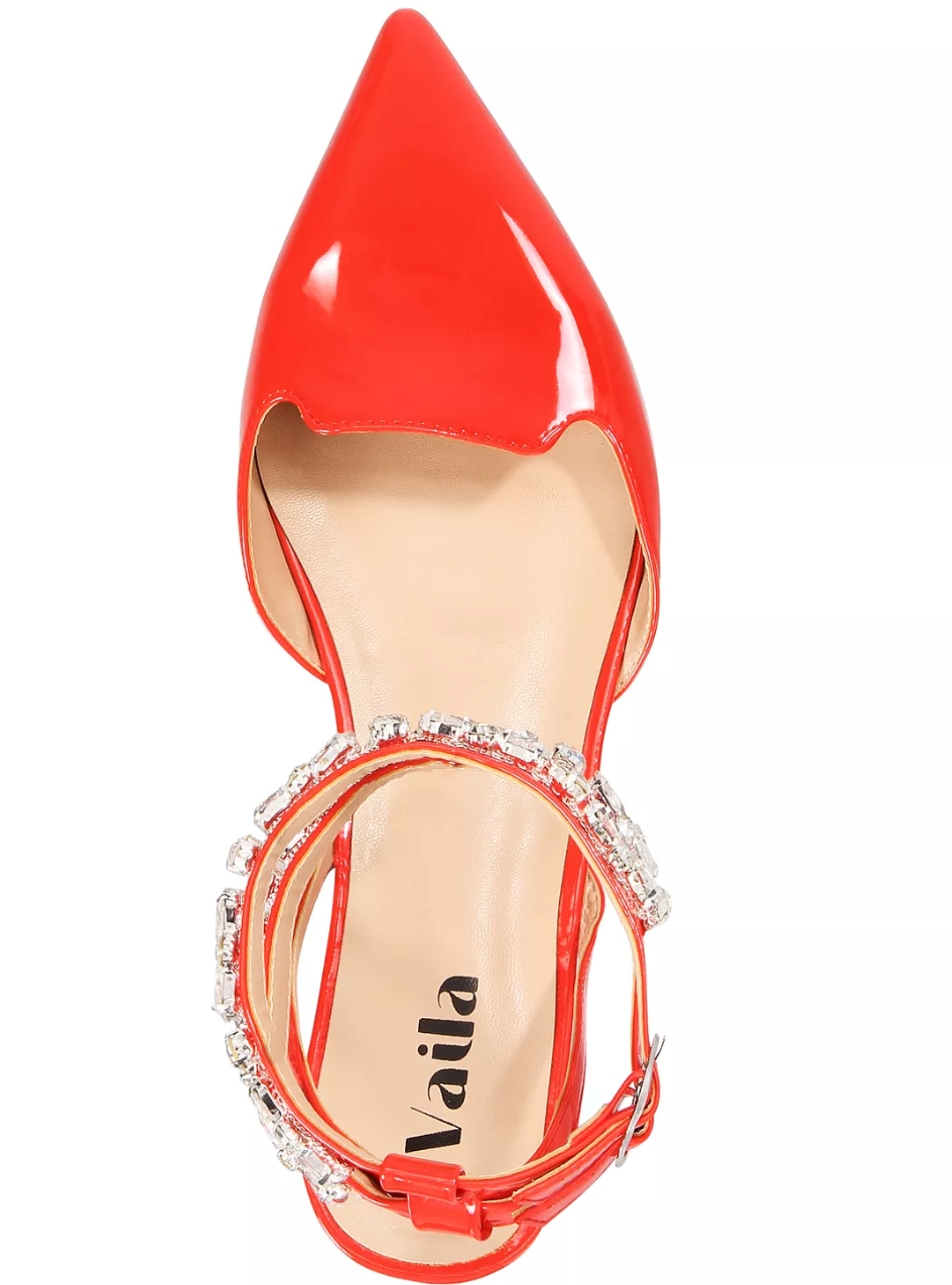 Red high-heeled shoe with a decorative strap on a white background