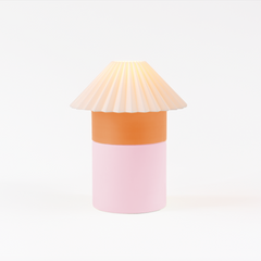 Decorative lamp with a pleated shade on a white background