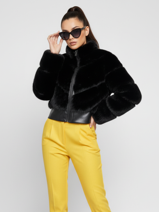Woman wearing a black fur jacket and yellow pants on a white background