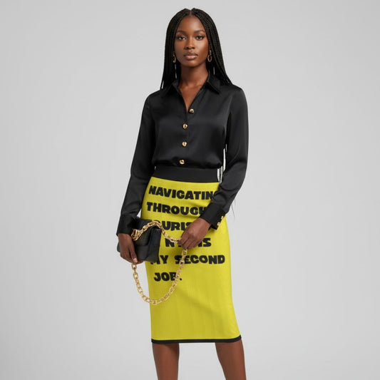 Woman wearing a black blouse and yellow skirt with text, holding a gold chain bag on a gray background