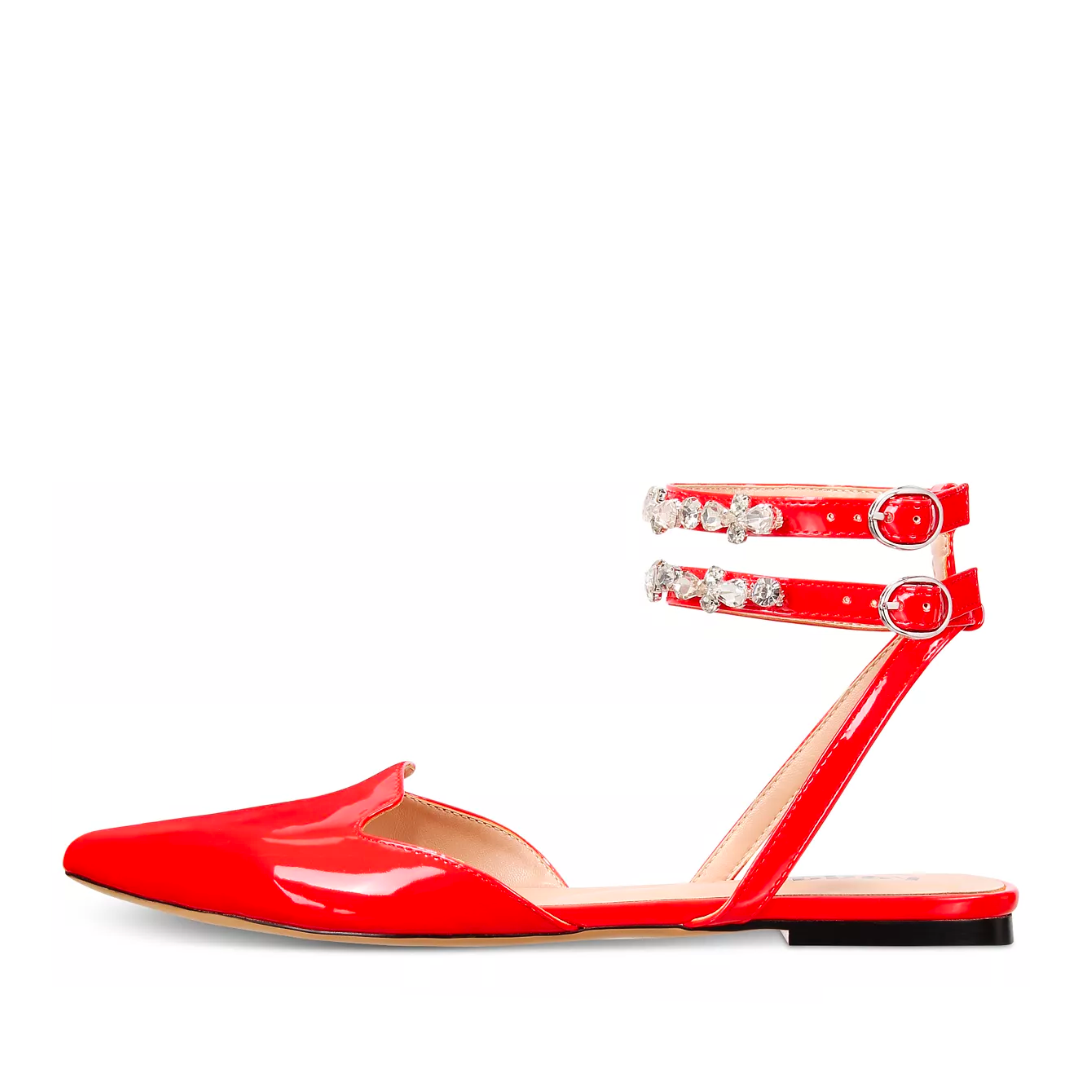 Red flat shoe with embellished straps on a white background