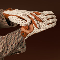 Close-up of a beige and brown glove with a plaid jacket on a dark background