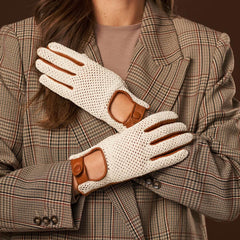 Person wearing cream gloves with brown accents and a plaid coat.