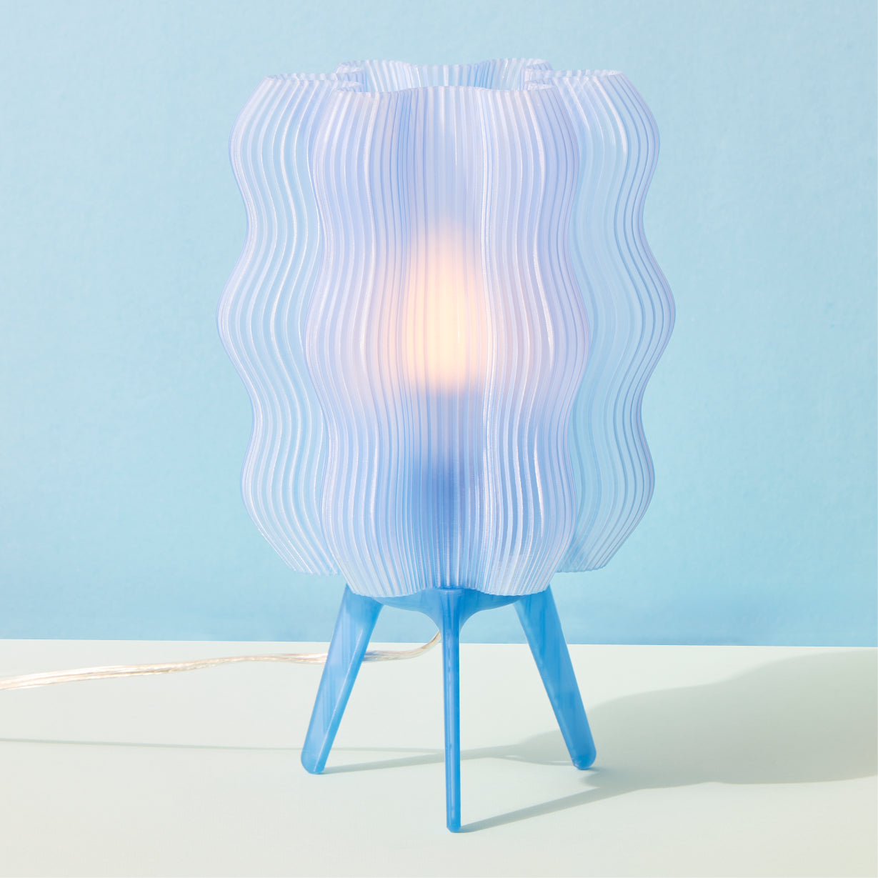 Table lamp with wavy design on a blue background