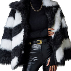 Person wearing a black and white fur coat with a gold chain and belt on a white background
