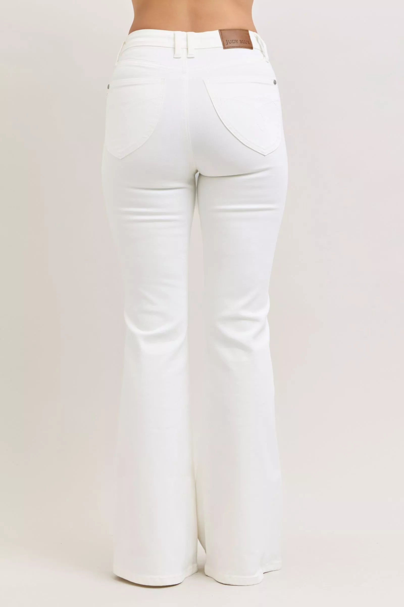 White jeans on a plain background