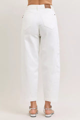 White jeans worn by a person on a plain background
