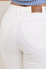 White pants with a visible 'Judy Blue' brand label.