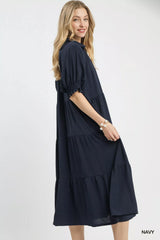 Woman wearing a navy dress on a white background