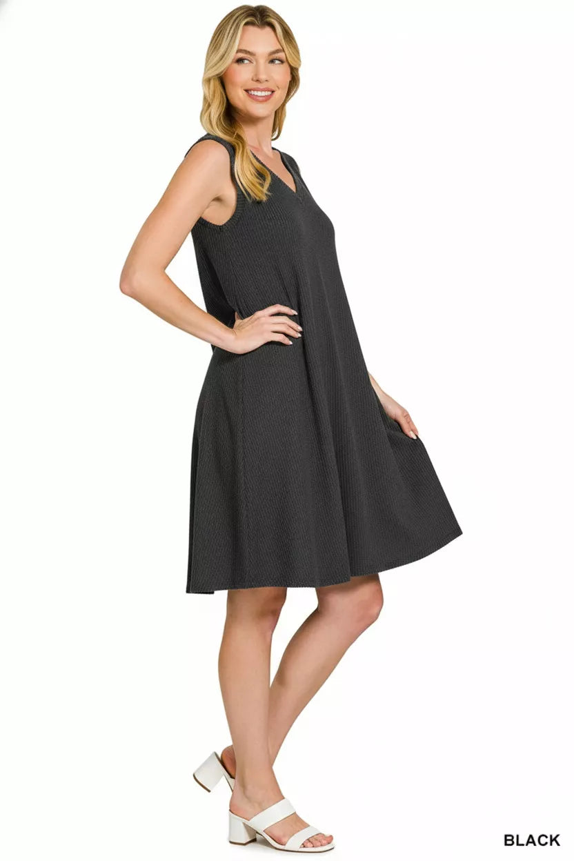 Woman wearing a black sleeveless dress on a white background