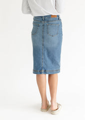 Light blue denim skirt worn by a person on a white background