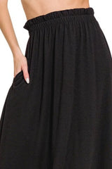Black skirt worn by a person with a white background