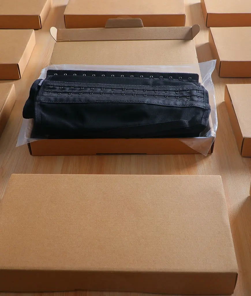 Black fabric in a cardboard box on a wooden surface