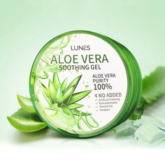A jar of Aloe Vera soothing gel with a green lid, alongside slices of aloe vera and aloe leaves. The label on the jar indicates it is 100% pure Aloe Vera gel.