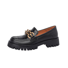 Black loafer shoe with chunky sole on a white background