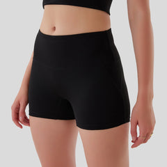 Black high-waisted shorts worn by a person on a plain background