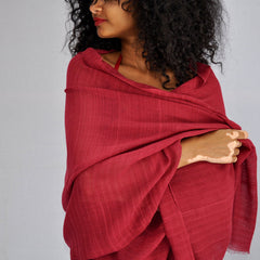 Woman wearing a red scarf against a gray background