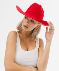 Woman wearing a red cowboy hat on a white background