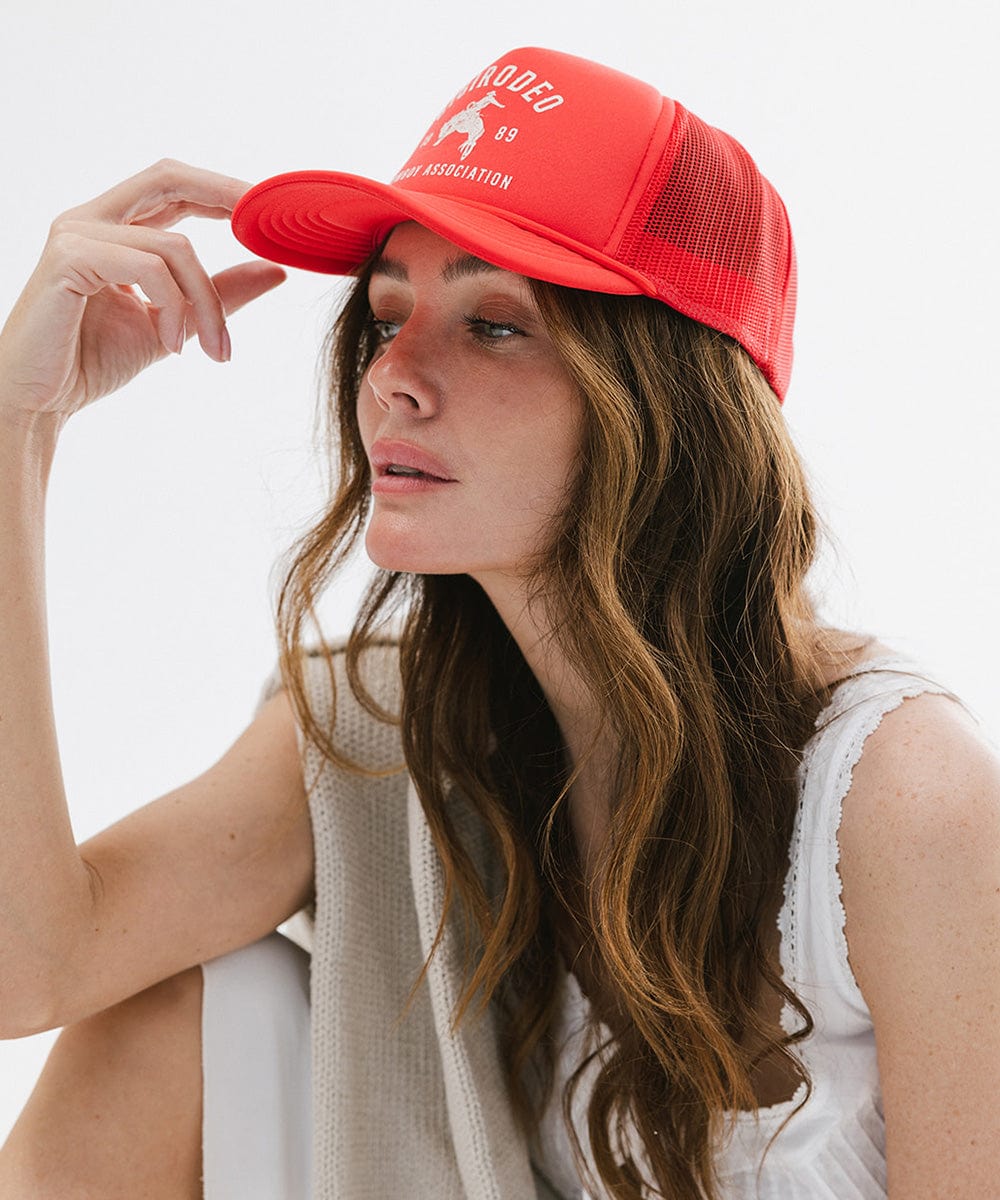 Woman wearing a red cap with text on a white background