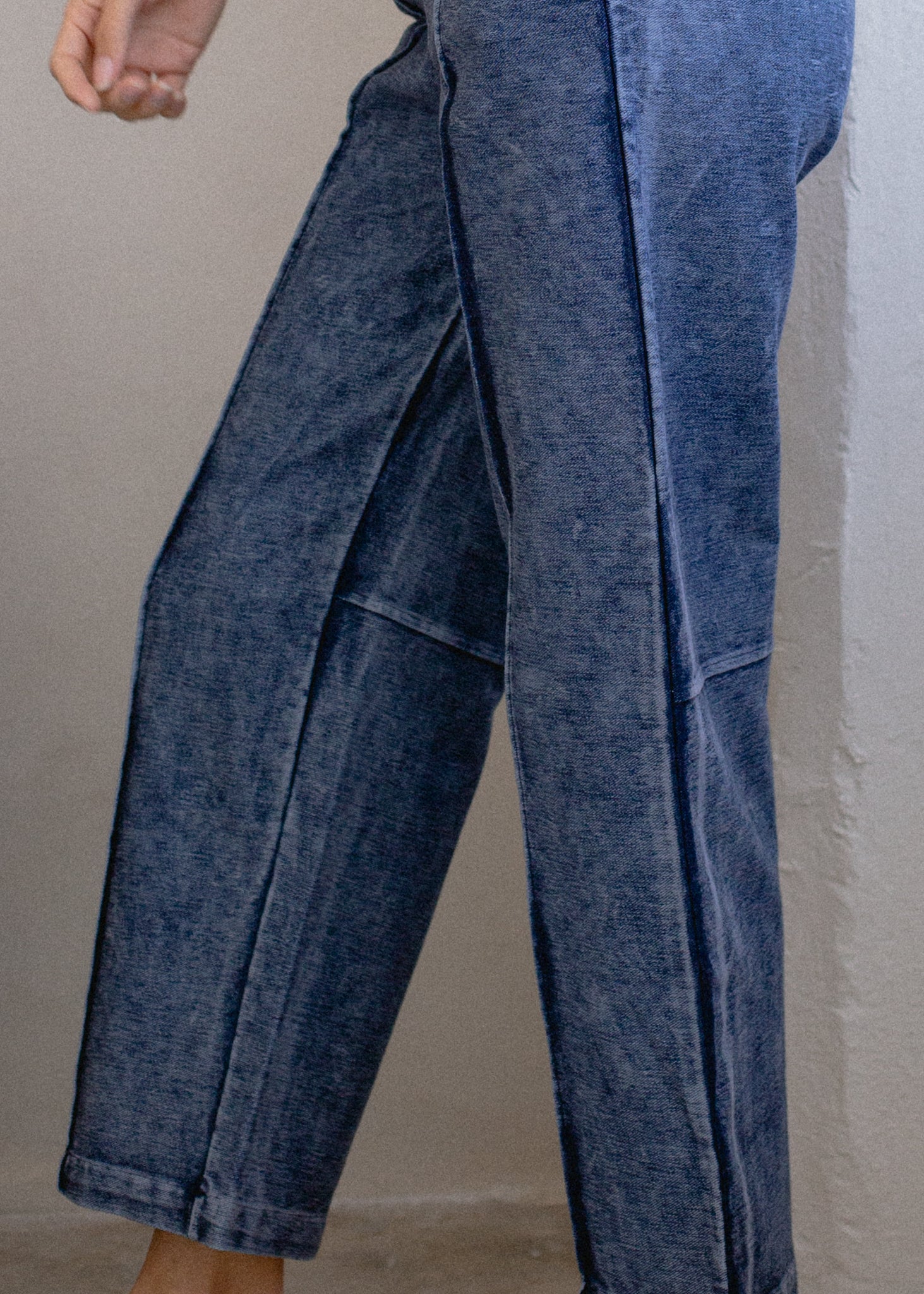 Blue denim pants on a plain background