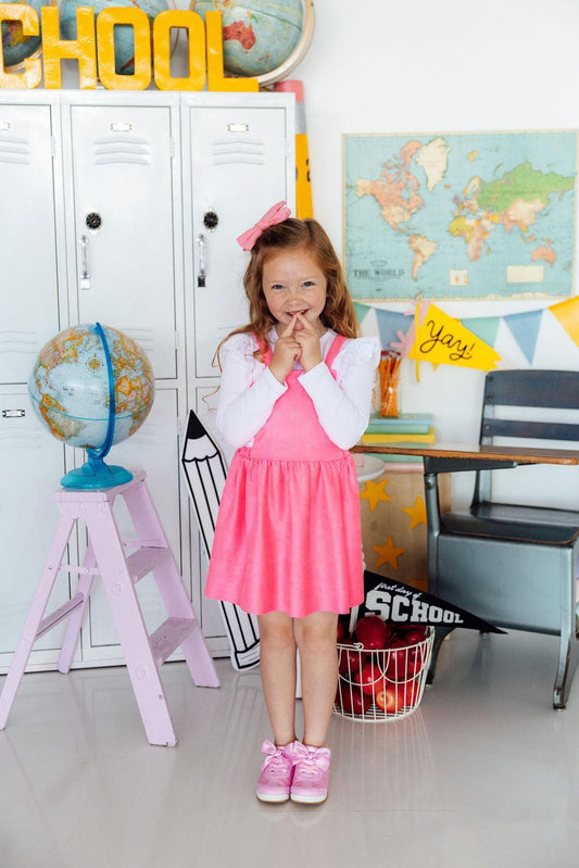 Young girl in a classroom setting with educational decor