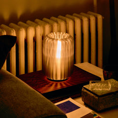 Decorative lamp on a table with a radiator in the background