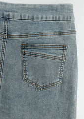 Close-up of a blue denim pocket on a white background