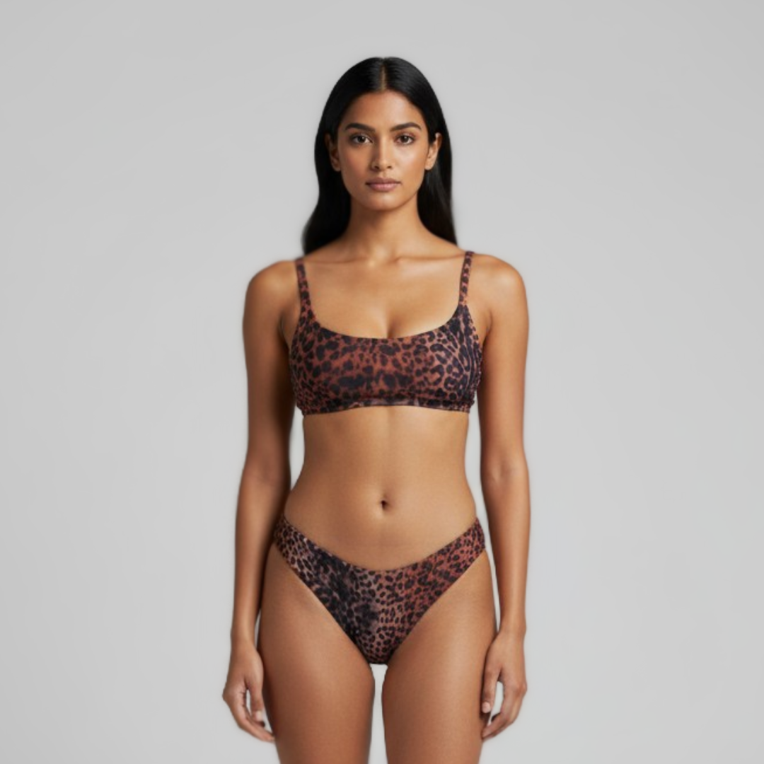 Woman wearing a leopard print bikini against a gray background