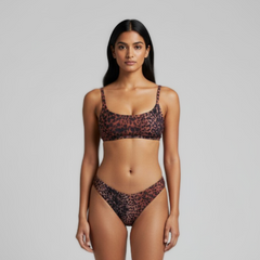 Woman wearing a leopard print bikini against a gray background