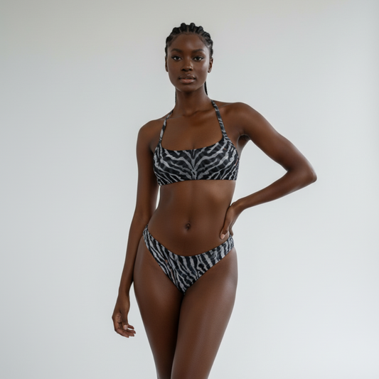 Woman wearing a zebra print bikini against a plain background