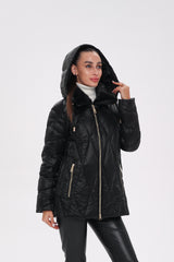 Woman wearing a black quilted jacket with a hood on a white background
