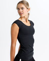 Woman wearing a black sleeveless top on a white background