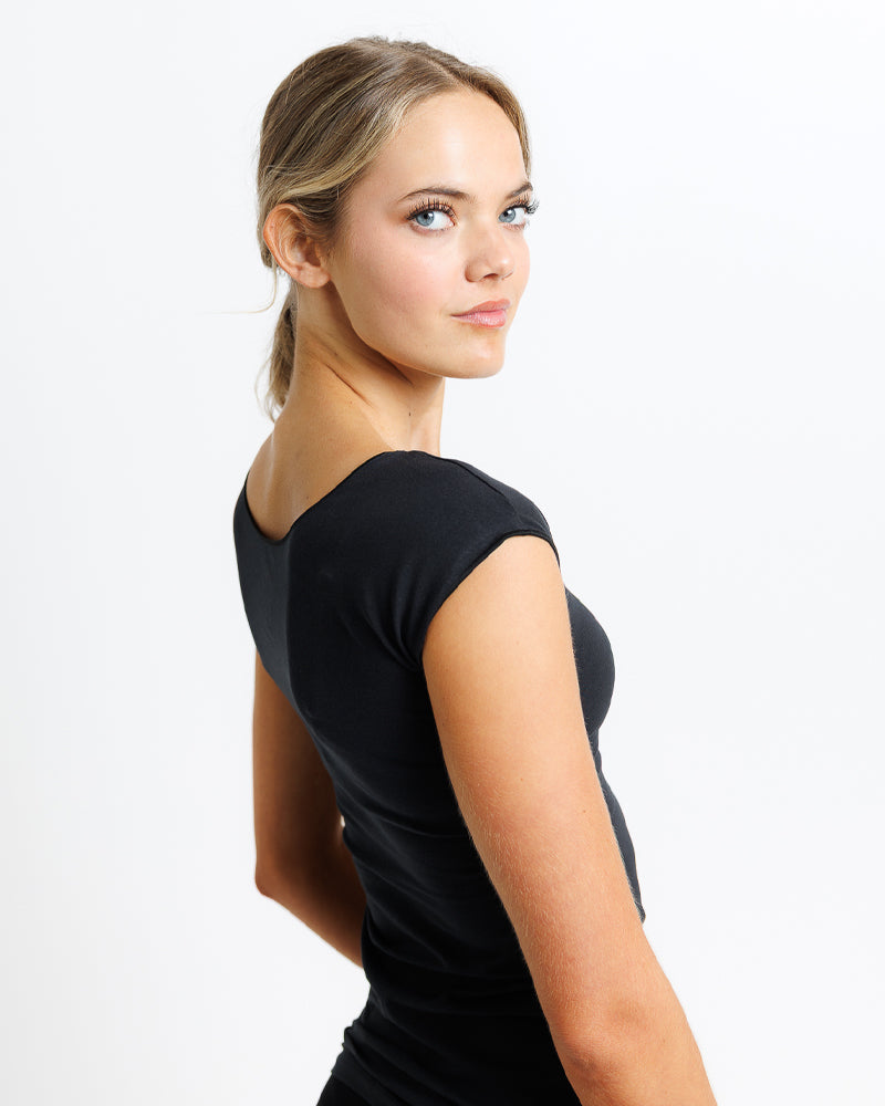 Woman wearing a black dress against a white background