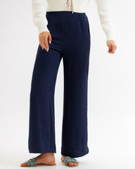 Navy blue wide-leg pants worn by a person on a white background