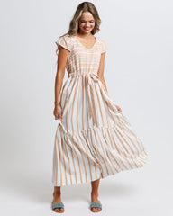 Woman wearing a striped dress on a white background