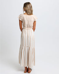 Woman wearing a striped dress on a white background