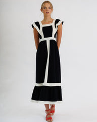 Woman wearing a black and white dress on a white background