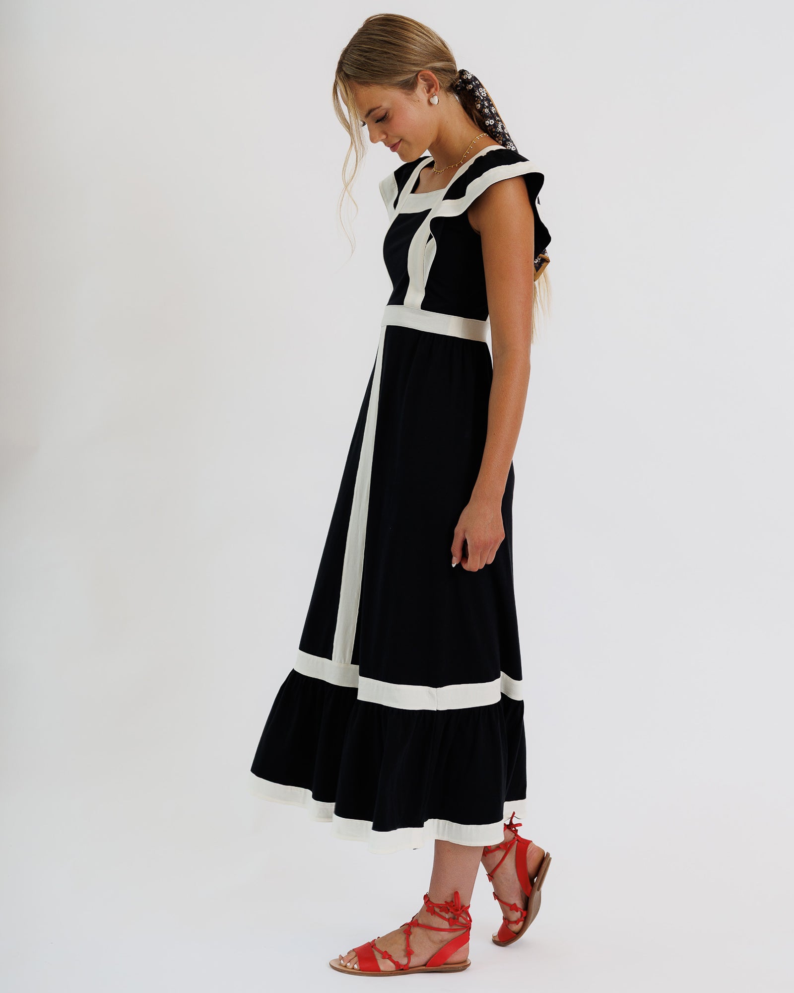 Woman wearing a black and white dress on a white background