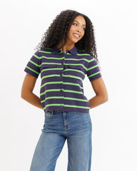 Woman wearing a striped shirt and jeans on a white background