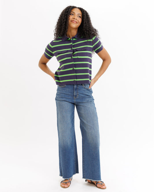 Woman wearing a striped shirt and jeans on a white background